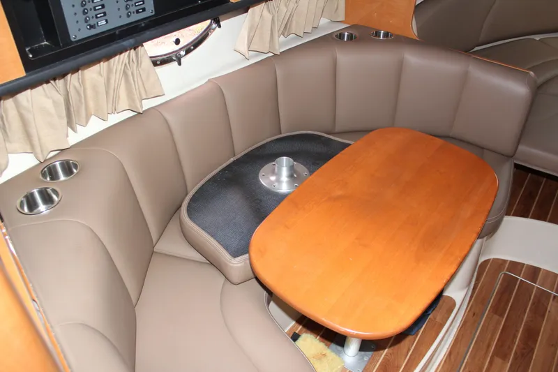 Slide: The Image of 2008 Chaparral Signature 290 interior with brown seating and wooden table. - 33