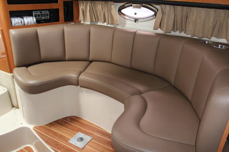 Slide: The Image of 2008 Chaparral Signature 290 interior with brown leather seating and wood flooring. - 35