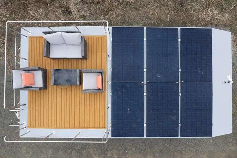 Slide: The Image of Aerial view of 2024 Waterlodge Apart M rooftop with solar panels and outdoor seating. - 11