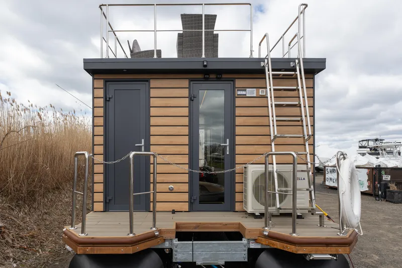 Slide: The Image of 2024 Waterlodge Apart M houseboat with rooftop deck and modern exterior design. - 16