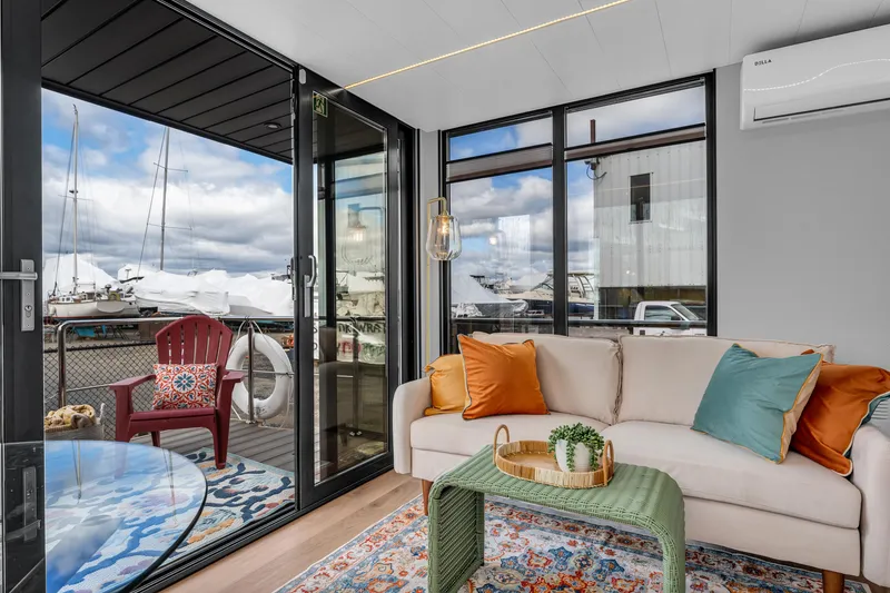 Slide: The Image of Modern Waterlodge Apart M 2024 interior with cozy seating, vibrant decor, and marina view. - 22