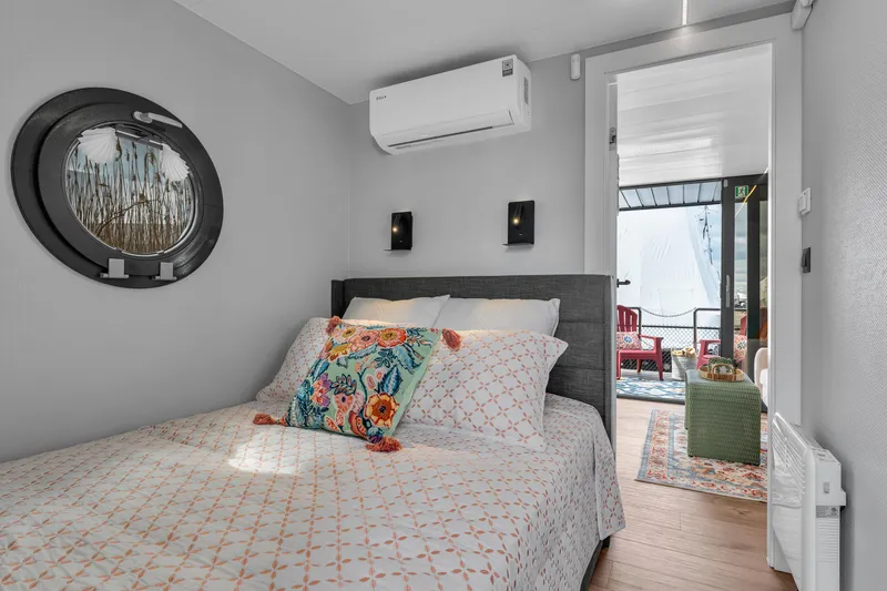 Slide: The Image of Cozy bedroom in 2024 Waterlodge Apart M with modern decor and outdoor view. - 25