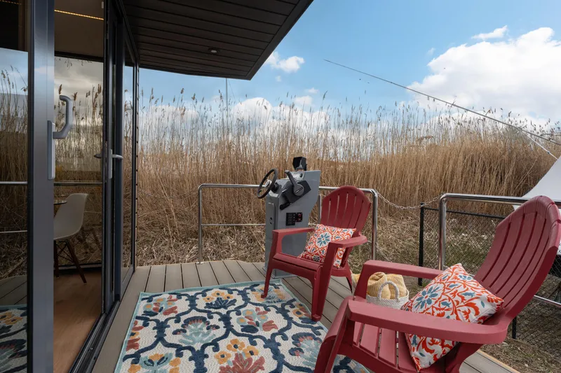 Slide: The Image of Waterlodge Apart M 2024 model with outdoor seating and scenic view. - 3