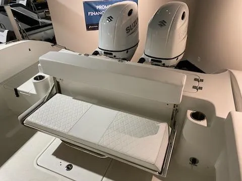 Slide: The Image of 2024 Sea Pro 259 Sport boat with dual Suzuki outboard engines and foldable rear bench seat. - 10