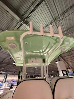 Slide: The Image of 2024 Sea Pro 259 Sport boat with green T-top and rod holders. - 11