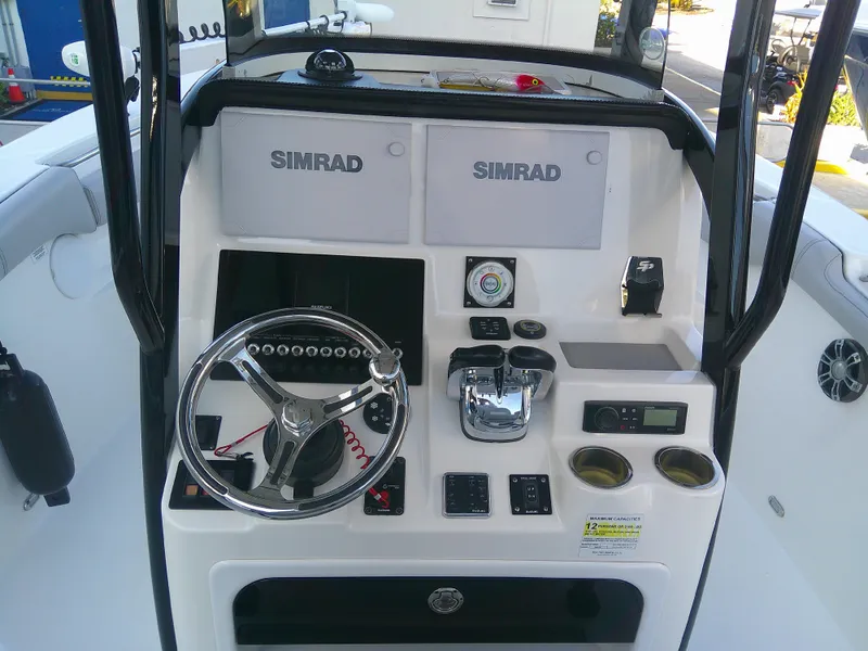 Slide: The Image of 2020 Sea Pro 259 Center Console boat dashboard with Simrad electronics. - 14
