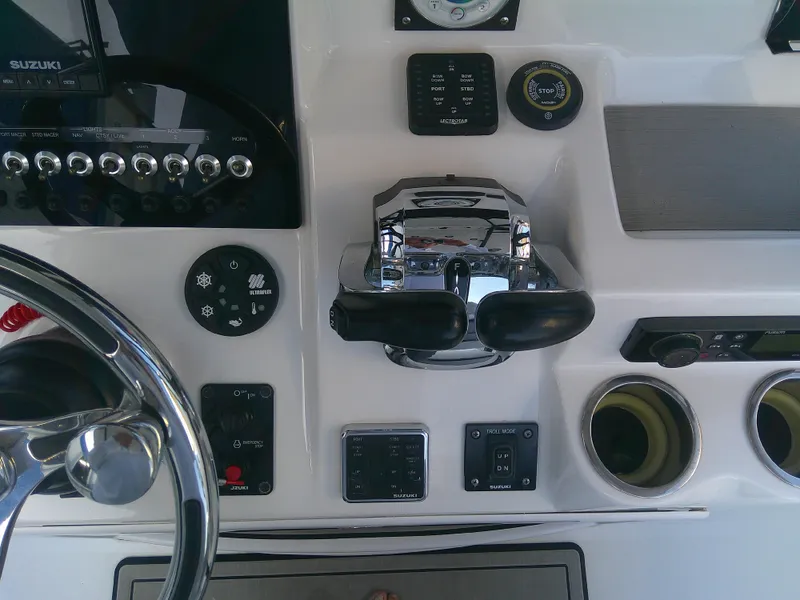 Slide: The Image of 2020 Sea Pro 259 Center Console boat dashboard with steering wheel and controls. - 17