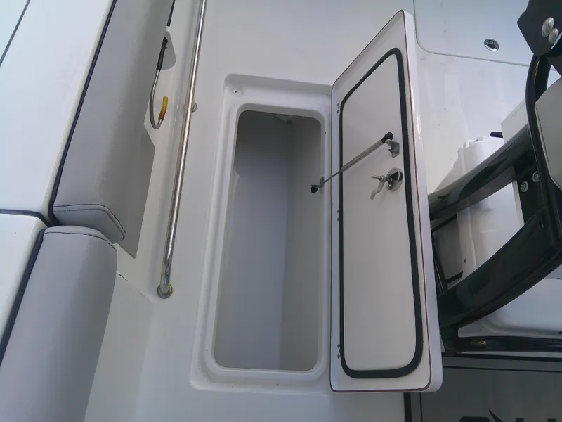 Slide: The Image of Open storage compartment on 2020 Sea Pro 259 Center Console boat. - 18
