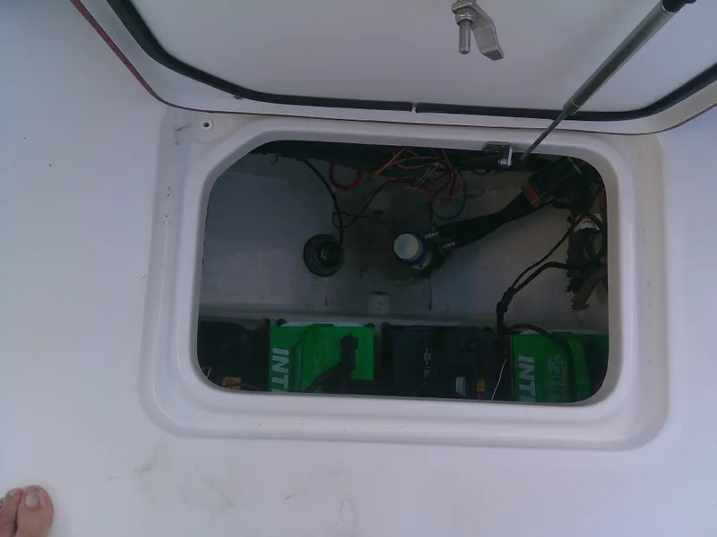 Slide: The Image of 2020 Sea Pro 259 Center Console battery compartment with wiring and components. - 19