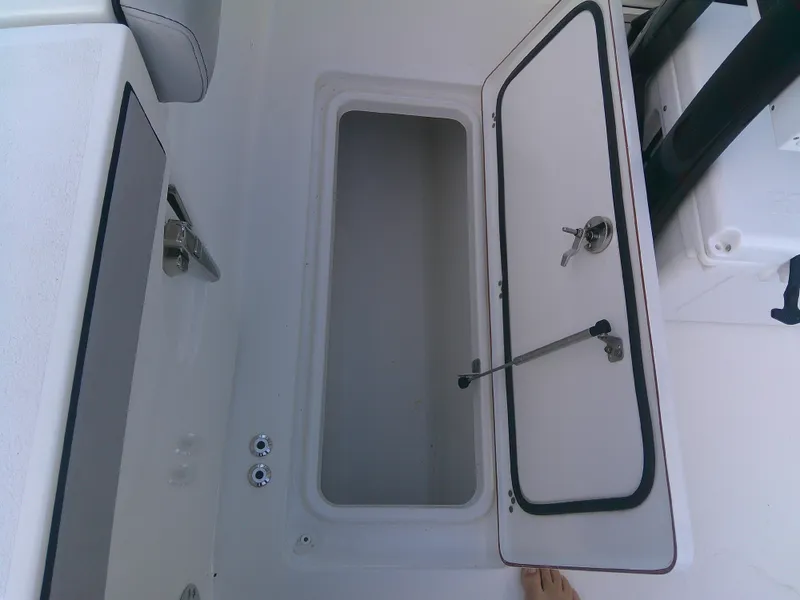 Slide: The Image of Open storage compartment on 2020 Sea Pro 259 Center Console boat. - 20