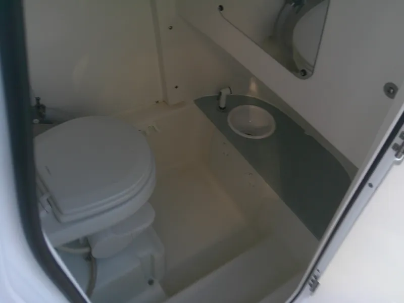Slide: The Image of 2020 Sea Pro 259 Center Console boat interior bathroom with toilet and sink. - 25