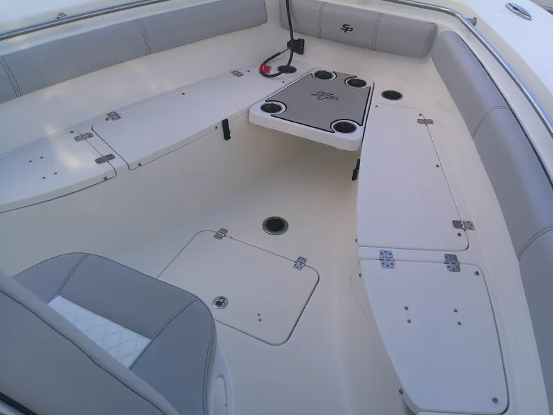 Slide: The Image of 2020 Sea Pro 259 Center Console boat interior with seating and storage compartments. - 26
