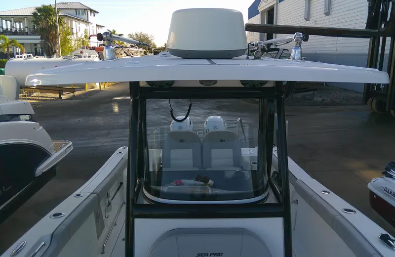 Slide: The Image of 2020 Sea Pro 259 Center Console boat docked, showcasing helm and seating area. - 30