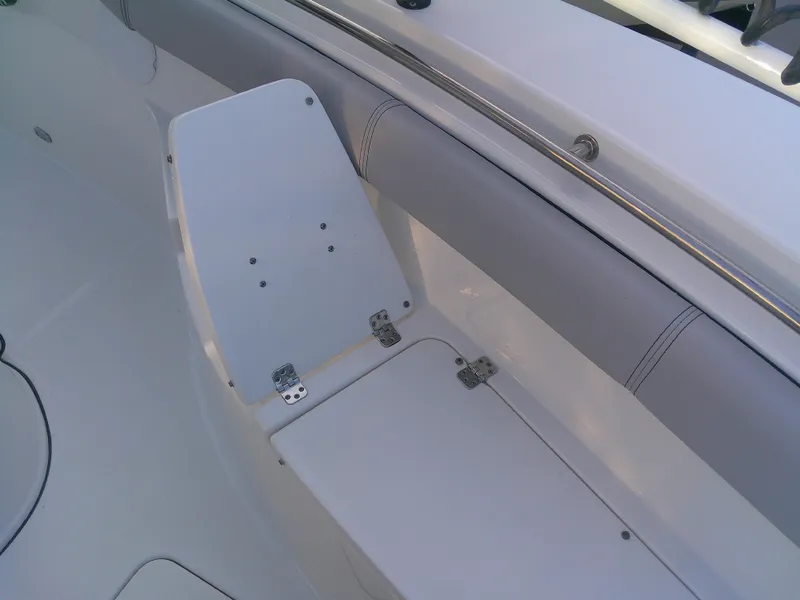 Slide: The Image of 2020 Sea Pro 259 Center Console boat seating area with white cushioned bench. - 31