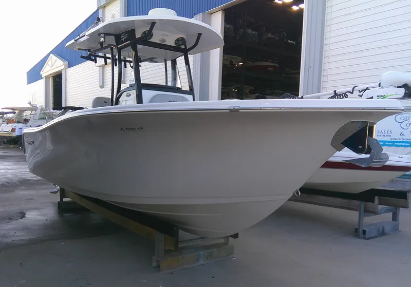 Slide: The Image of 2020 Sea Pro 259 Center Console boat in a marina setting. - 4