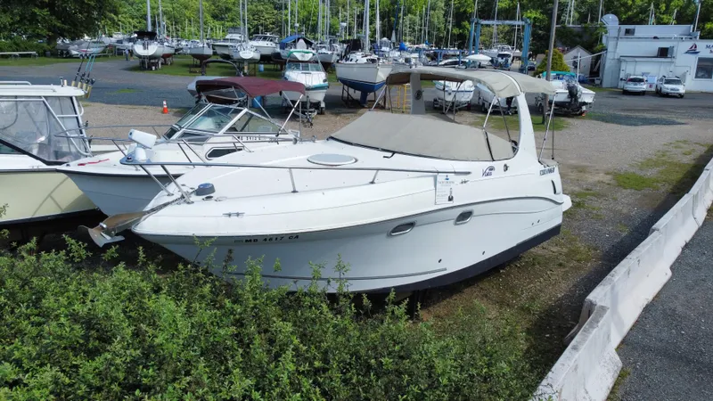 Slide: The Image of 2003 Four Winns 268 Vista boat docked at a marina with other boats. - 0