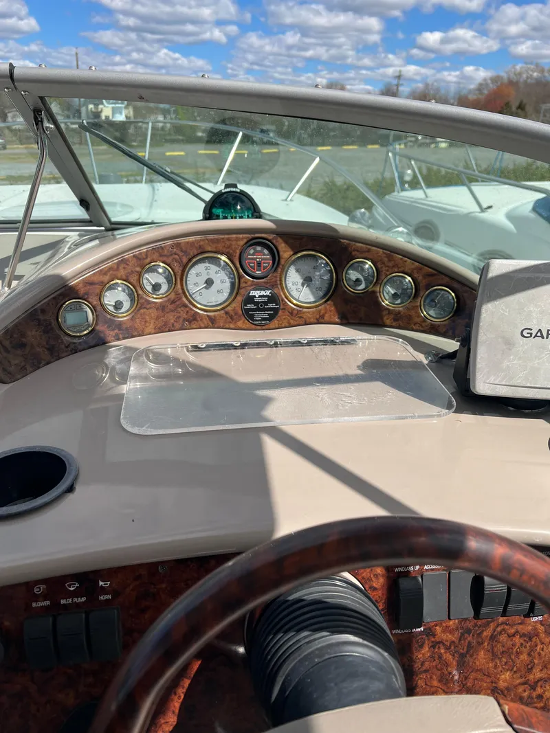 Slide: The Image of 2003 Four Winns 268 Vista boat dashboard with gauges and controls. - 20