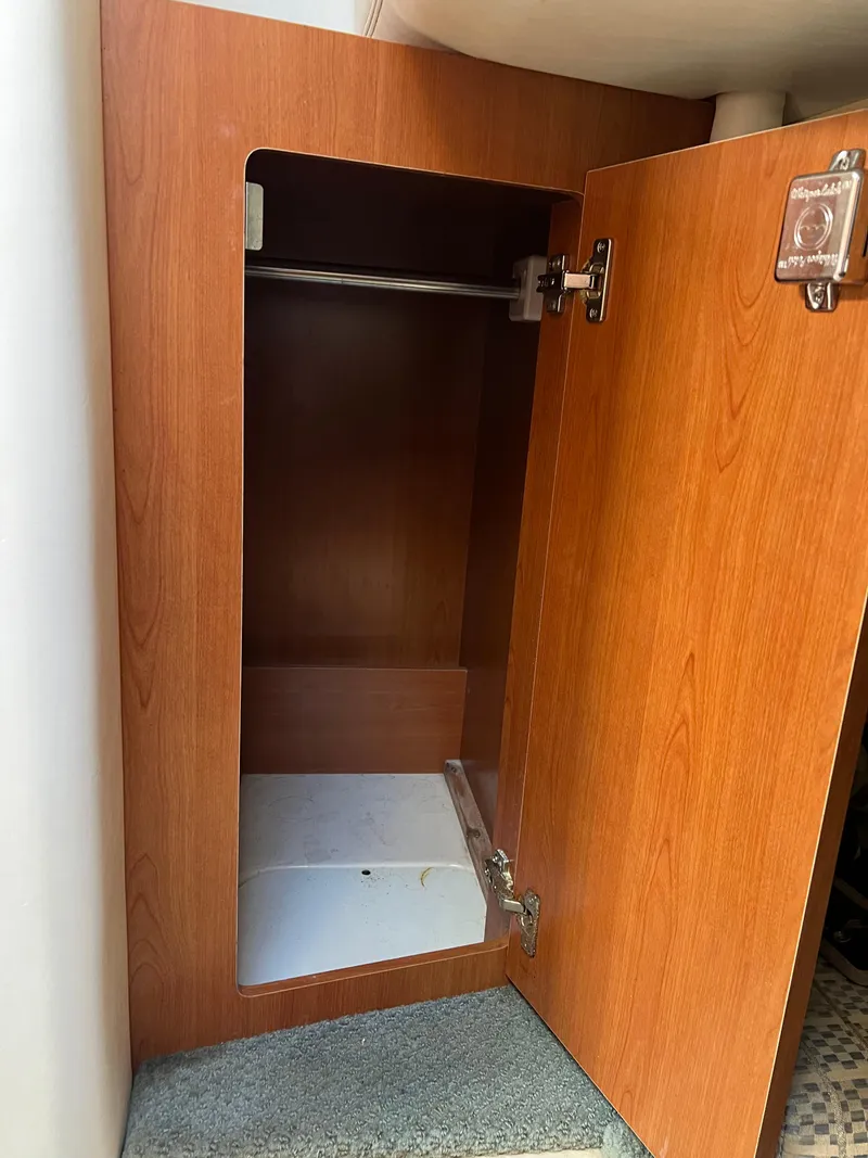 Slide: The Image of Open wooden cabinet inside 2003 Four Winns 268 Vista boat. - 32