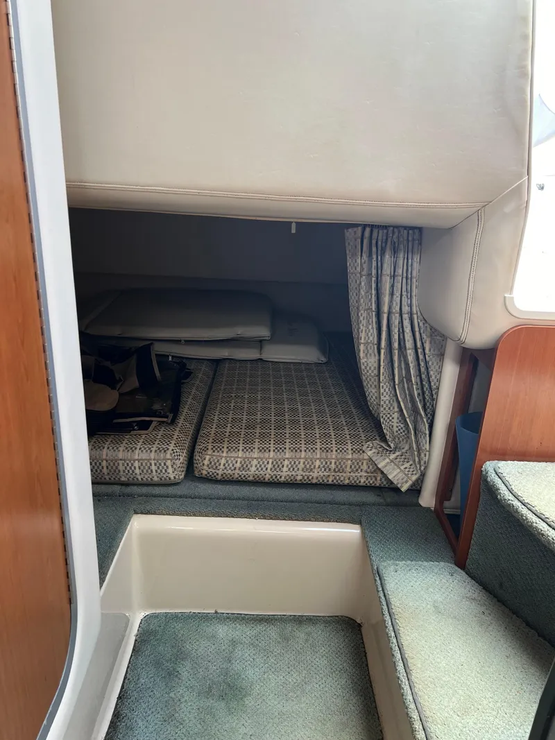 Slide: The Image of Interior cabin of a 2003 Four Winns 268 Vista boat with cushioned seating. - 33