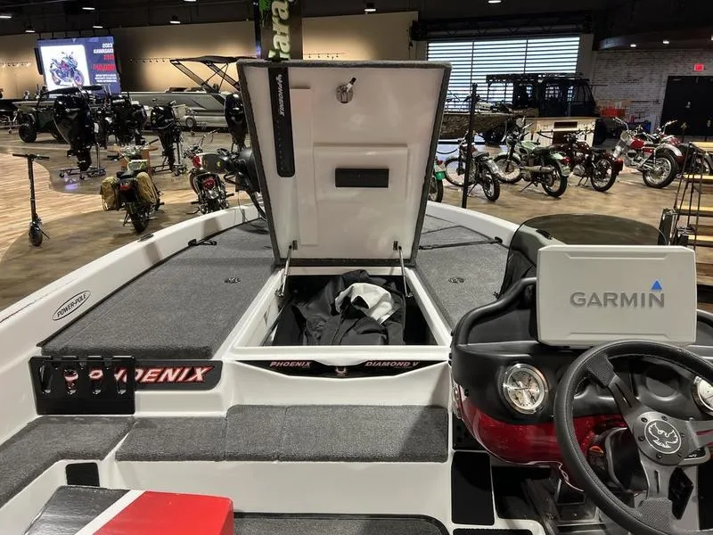 Slide: The Image of 2024 Phoenix 819 Pro boat interior with Garmin navigation system at a showroom. - 3