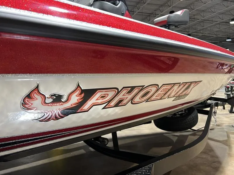Slide: The Image of 2024 Phoenix 819 Pro boat with red and silver detailing in a showroom. - 6