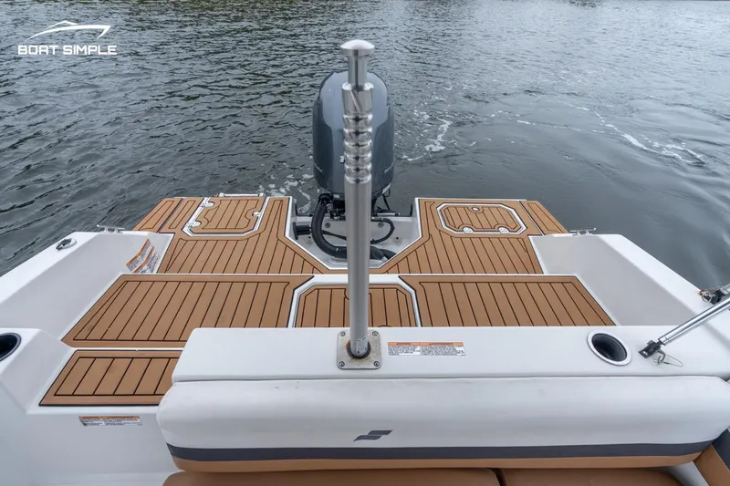 Slide: The Image of 2022 Starcraft SVX 211 OB boat stern with teak flooring and outboard motor. - 7