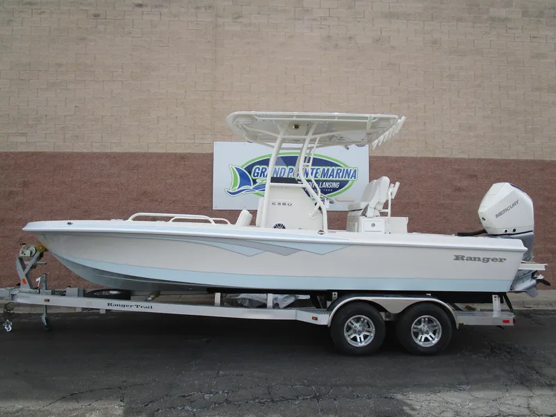 The Image of 2024 Ranger 2360 Bay boat on a trailer at a marina. - 1