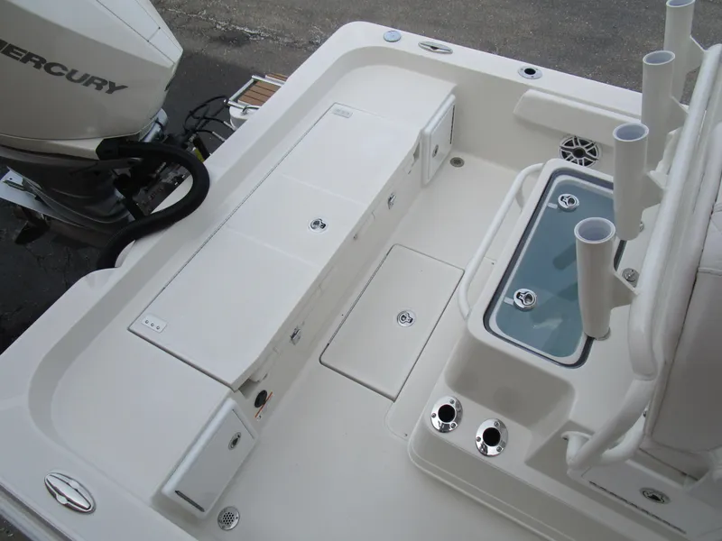 Slide: The Image of 2024 Ranger 2360 Bay boat deck with storage compartments and Mercury outboard motor. - 10