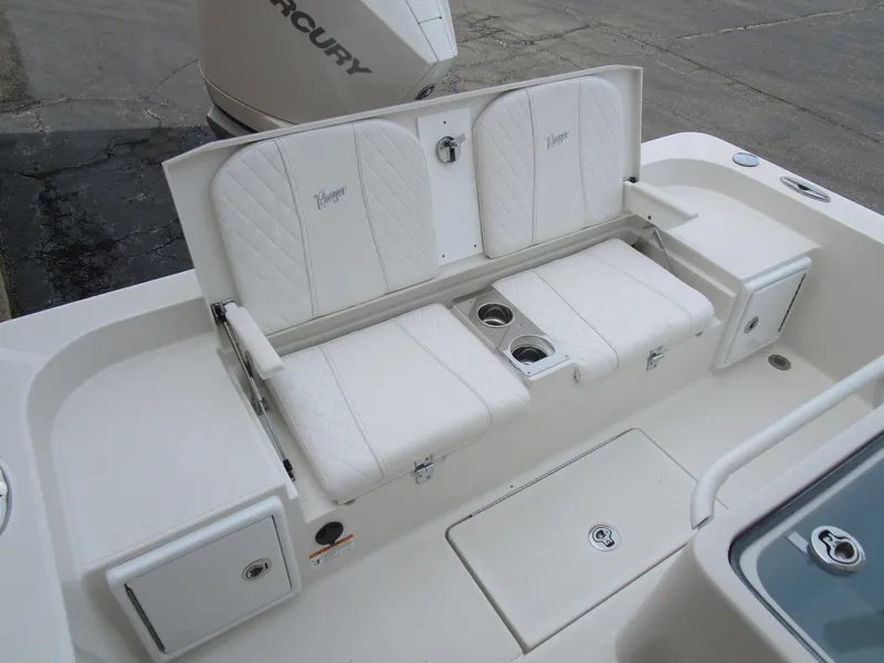 Slide: The Image of 2024 Ranger 2360 Bay boat with white cushioned seating and storage compartments. - 11