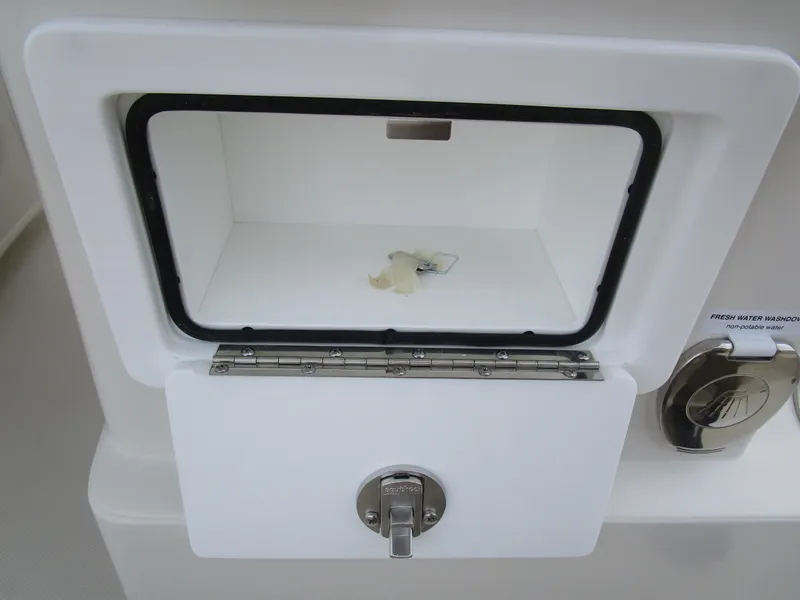 Slide: The Image of 2024 Ranger 2360 Bay boat storage compartment with latch. - 17