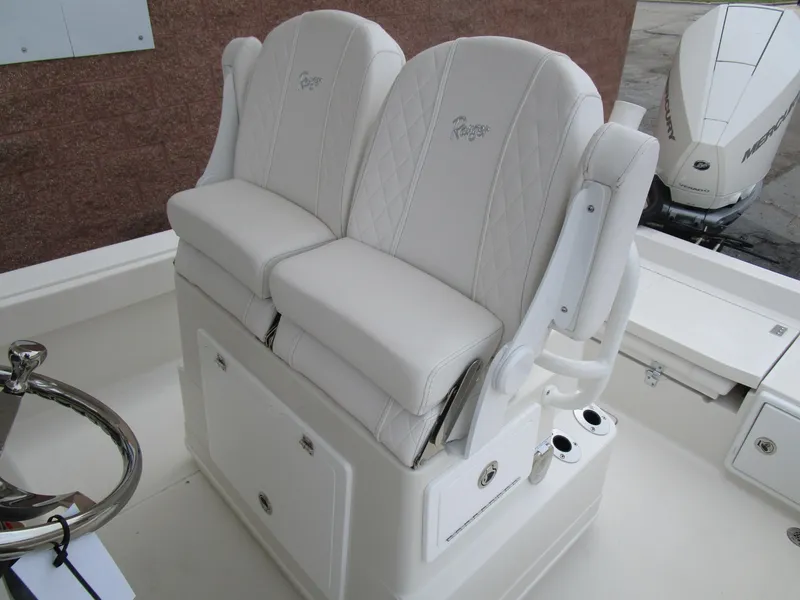 Slide: The Image of 2024 Ranger 2360 Bay boat with dual white cushioned seats. - 19