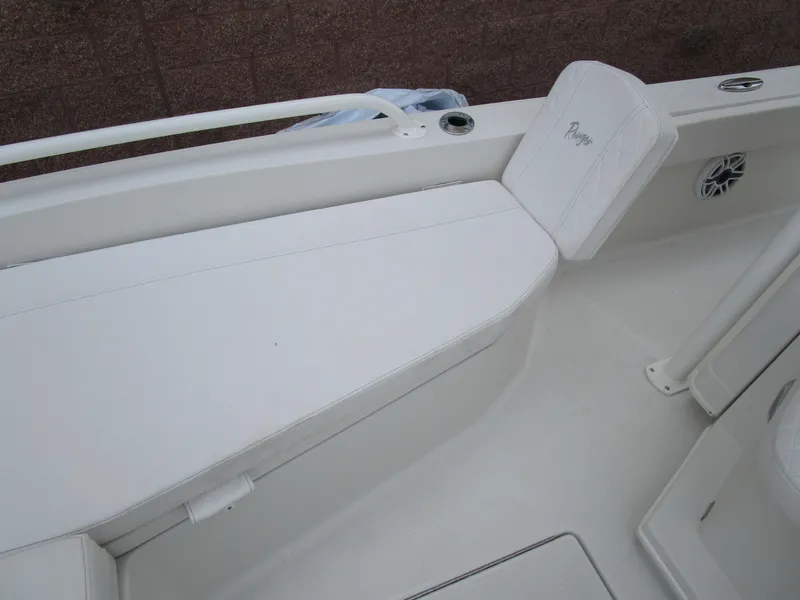 Slide: The Image of 2024 Ranger 2360 Bay boat interior with white seating and storage. - 32