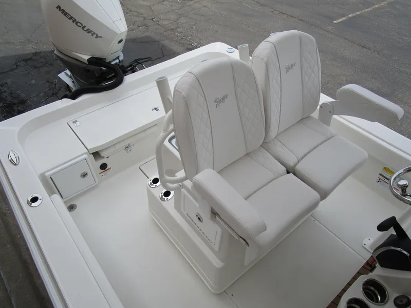 Slide: The Image of 2024 Ranger 2360 Bay boat with dual white captain's chairs and Mercury outboard engine. - 9