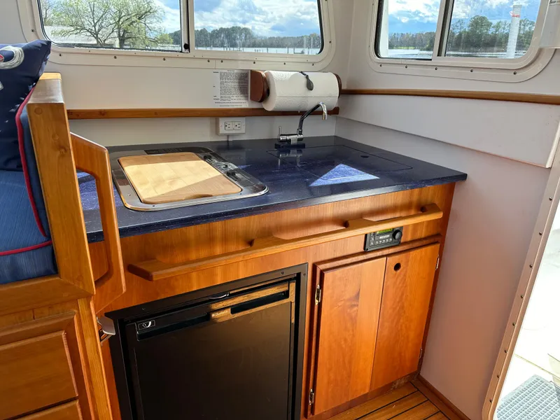 Slide: The Image of 2016 Custom Broad Creek 32 Downeast boat kitchen with wood cabinetry and compact appliances. - 14