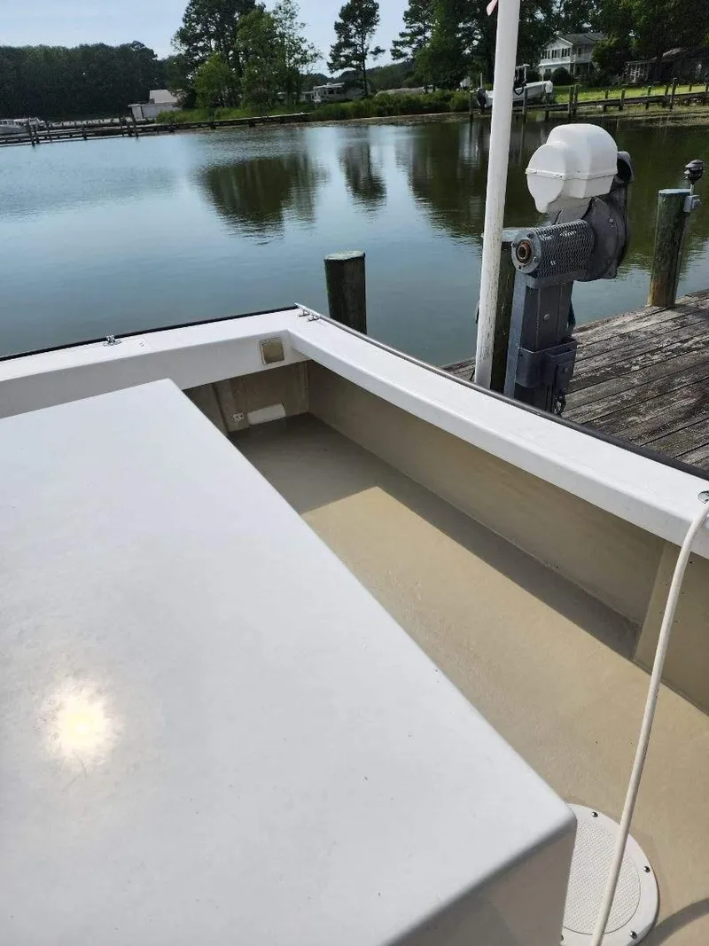 Slide: The Image of 2016 Custom Broad Creek 32 Downeast boat docked by a serene waterfront. - 23