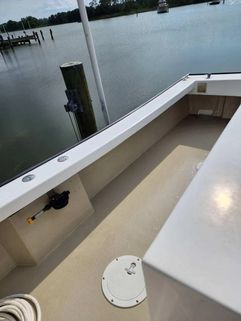 Slide: The Image of 2016 Custom Broad Creek 32 Downeast boat deck by calm waters. - 24