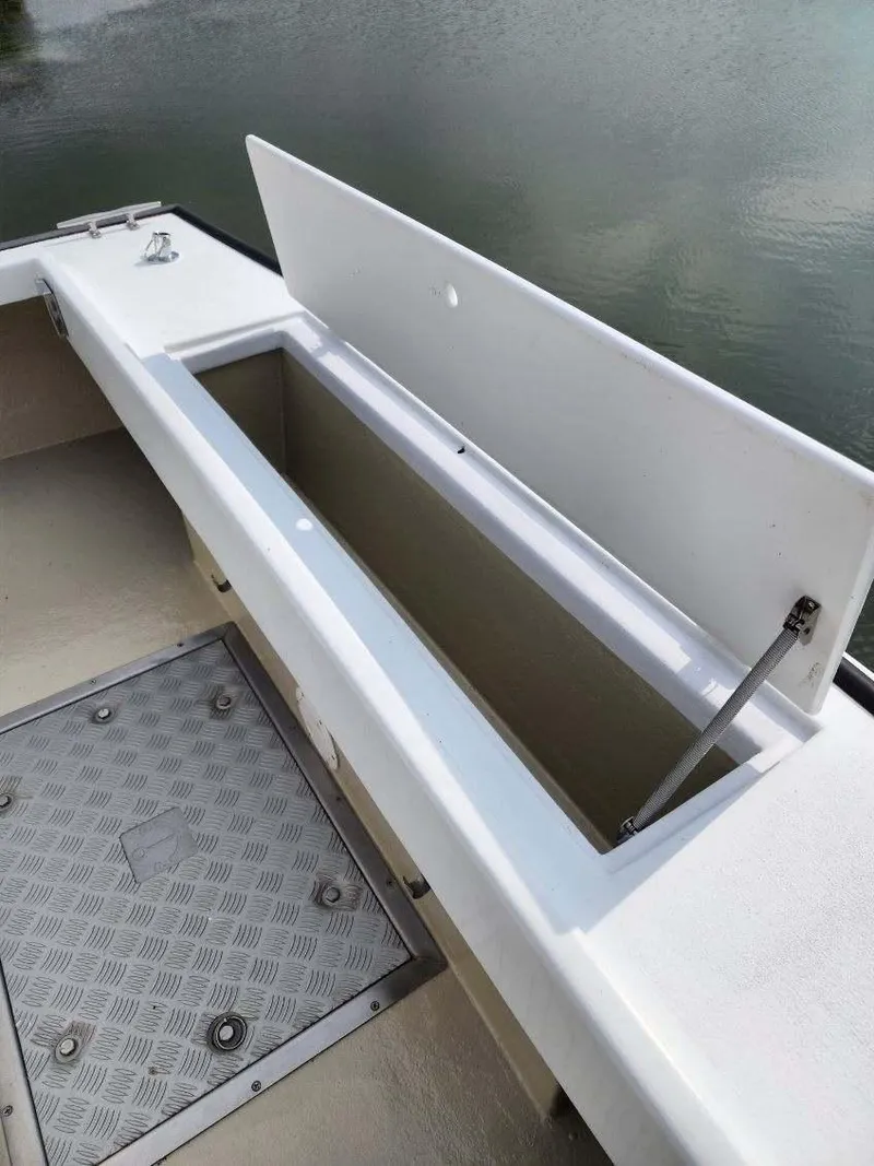 Slide: The Image of Open storage compartment on 2016 Custom Broad Creek 32 Downeast boat. - 25