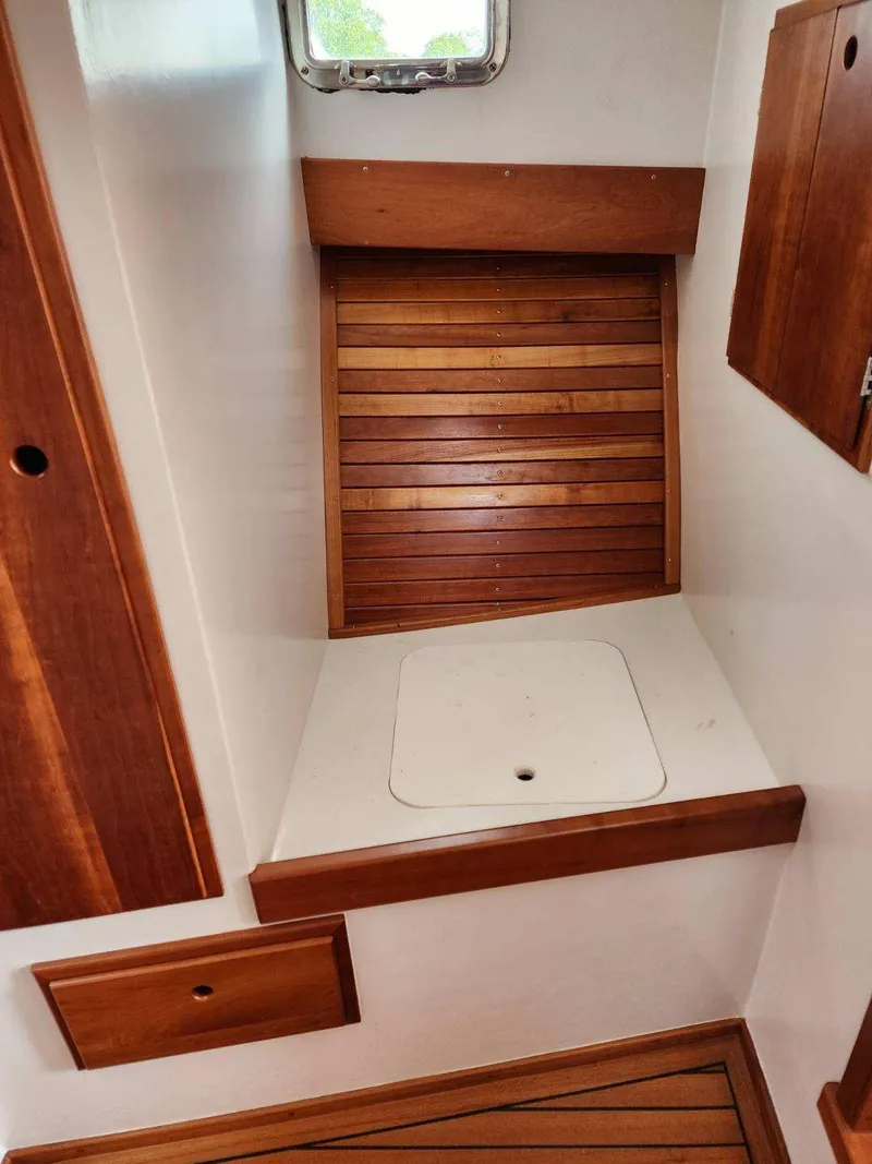Slide: The Image of Interior of 2016 Custom Broad Creek 32 Downeast boat with wooden accents and storage compartments. - 27