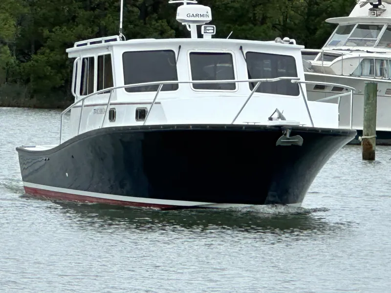 Slide: The Image of 2016 Custom Broad Creek 32 Downeast boat on water, featuring a sleek design and Garmin equipment. - 3