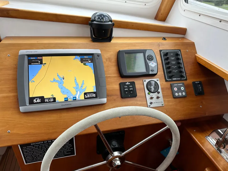 Slide: The Image of Helm of 2016 Custom Broad Creek 32 Downeast with navigation equipment and steering wheel. - 5