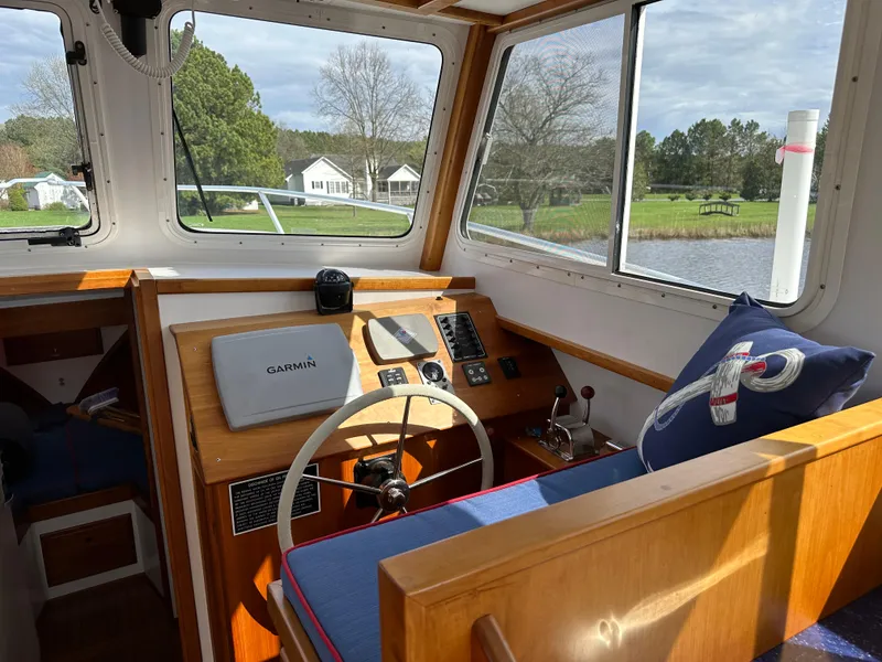 Slide: The Image of Interior of 2016 Custom Broad Creek 32 Downeast boat with steering wheel and navigation equipment. - 6
