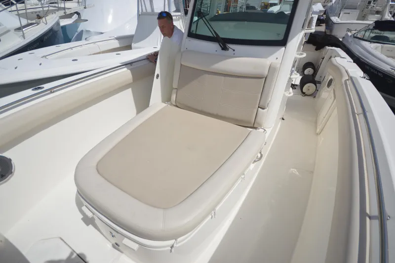 Slide: The Image of 2018 Boston Whaler 330 Outrage boat with cushioned seating area. - 10