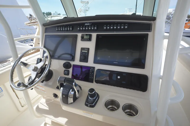 Slide: The Image of 2018 Boston Whaler 330 Outrage helm with advanced navigation and control systems. - 14