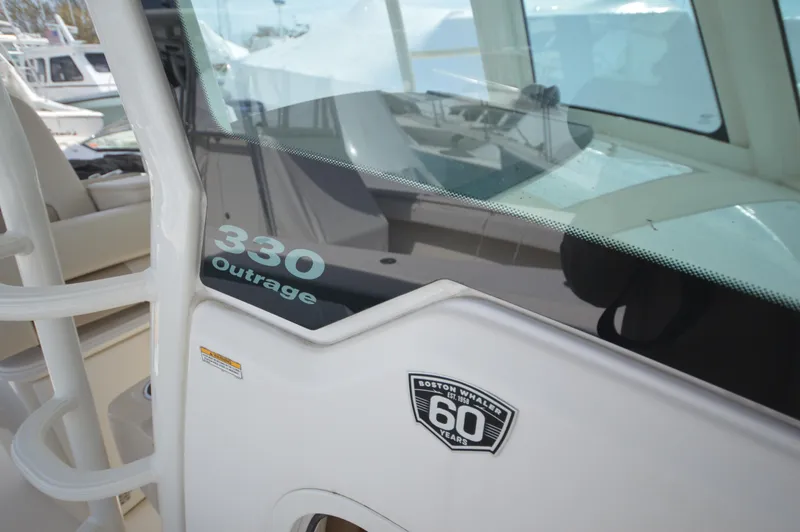 Slide: The Image of 2018 Boston Whaler 330 Outrage boat with 60th anniversary badge. - 18