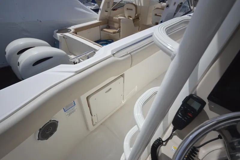 Slide: The Image of 2018 Boston Whaler 330 Outrage boat interior with dual outboard engines. - 20