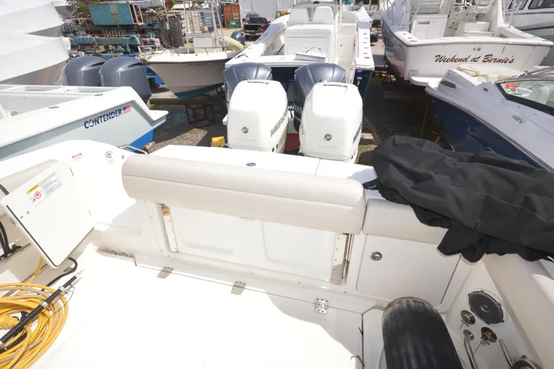 Slide: The Image of 2018 Boston Whaler 330 Outrage boat with twin outboard engines in a marina. - 21