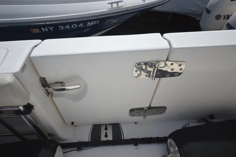Slide: The Image of 2018 Boston Whaler 330 Outrage boat with secure latch and hinge details. - 24