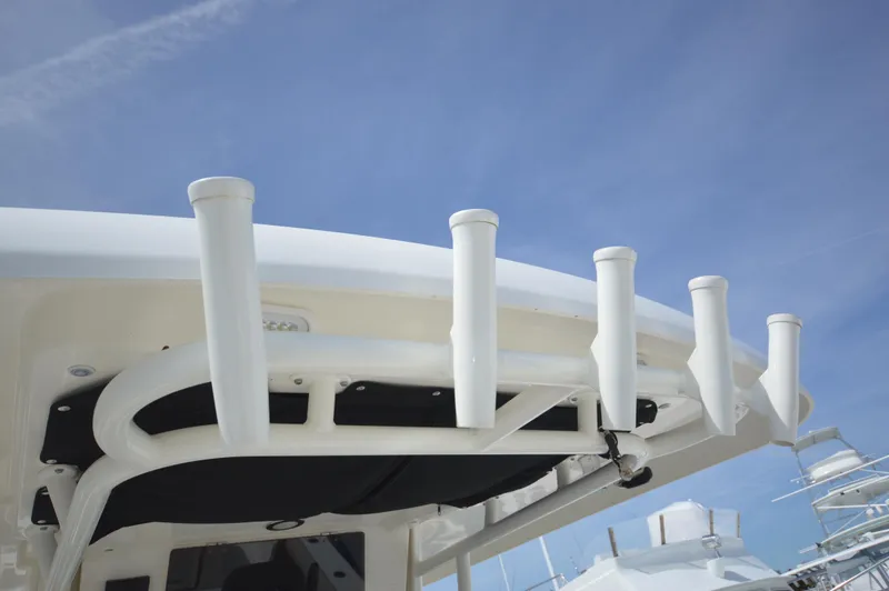 Slide: The Image of Rod holders on a 2018 Boston Whaler 330 Outrage boat against a clear sky. - 26
