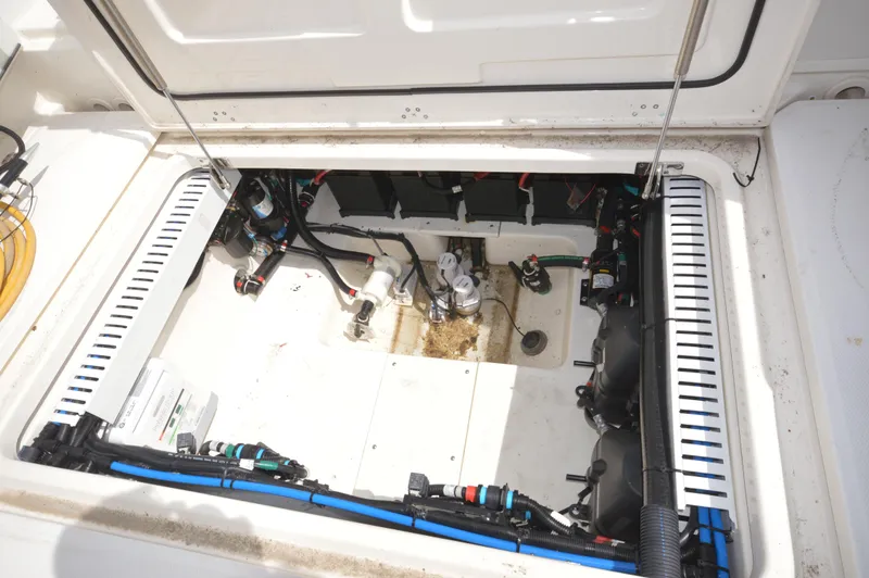 Slide: The Image of 2018 Boston Whaler 330 Outrage engine compartment with visible wiring and components. - 28