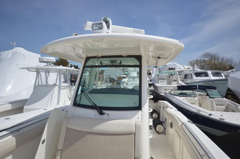 Slide: The Image of 2018 Boston Whaler 330 Outrage boat with center console and seating. - 8